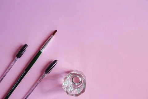 Materials for depilation of eyebrows on a pink background. Wooden stick for w 写真素材