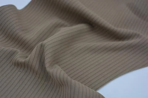 Materials, light green, brown thin fabric with texture and small lines. Stock Photos
