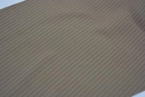 Materials, light green, brown thin fabric with texture and small lines. Stock Photos