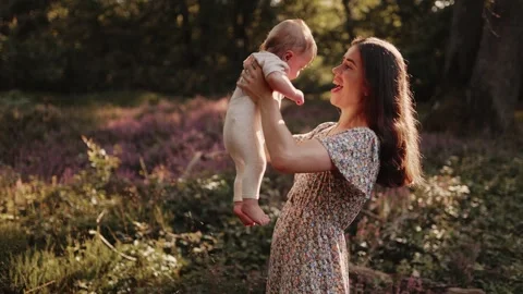 Maternal affection concept: mom playing and having fun with her baby Stock Footage 281864175