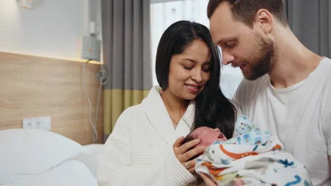 Maternity and Parenthood Concept. Happy parents in postnatal hospital with Stock Footage 248972762