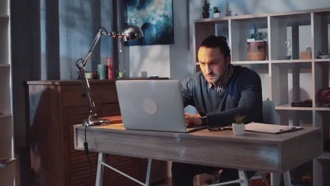 Mates prank their co-worker. Good-looking young male staying in the office late Stock Footage 84700293