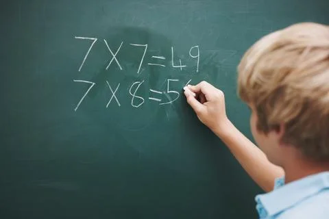 Math, boy and writing on chalkboard in classroom with problem solving, education Stock Photos