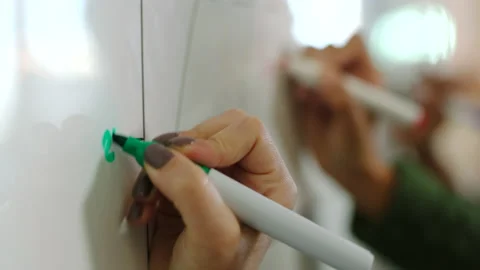 Math chart, graph and work or study team writing on a white board working solve Stock Footage 225539942