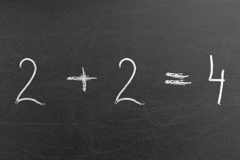 Math equation for beginners in the school written on a blackboard. 2 plus 2 is 4 Foto stock