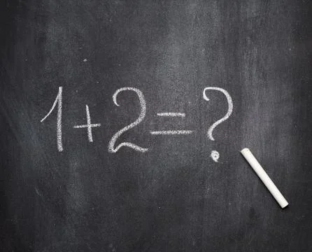 Math example written in white chalk on a black chalk board and white chalk Stock Photos