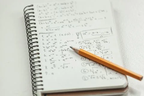 Math formulas are written in pencil on a piece of paper, math problems Stock-Fotos
