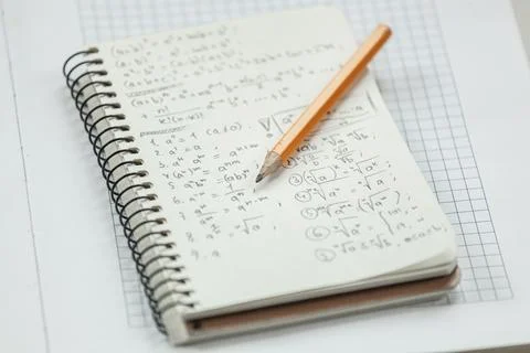 Math formulas are written in pencil on a piece of paper, math pr Stock Photos