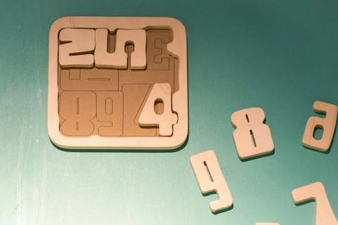 Math game for junior age with colored wooden signs of numbers Stock Photos
