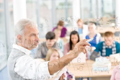 Math lesson at high school - students with professor Stock Photos