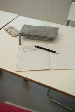 Math notebook lying open on desk in classroom Stock Photos