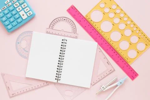 Math rulers supplies with open empty notebook flat lay Stock Photos