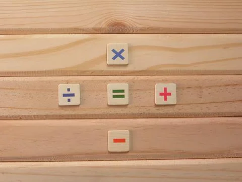 Math symbols Divide, Multiply, Add, Subtract and Equal to on wood background Stock Photos