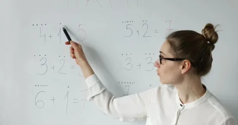 Math teacher explaining primary school basic mathematics on whiteboard in cla 動画素材 150442851