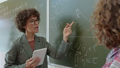 Math Teacher Explaining Problem To Student Stock Footage 237905774