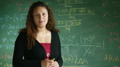 Math teacher in front of chalk board Stock Footage