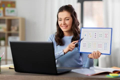 Math teacher having online class on laptop at home Stock Photos