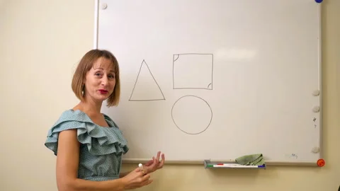 Math teacher stand in classroom and record online call for students Spbas. Woman Stock Footage 163813444