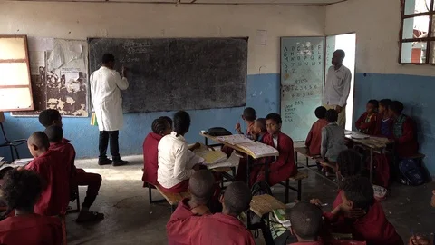 Math teacher writes on chalkboard in classroom Ethiopia, education Africa Stock Footage 119248507