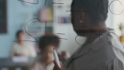 Math Teacher Writing Addition Problem on Glass Board Stock Footage 312051630