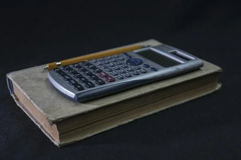 Math textbook, pencil and calculator Stock Photos