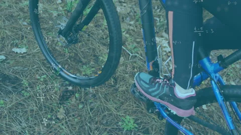 Mathematical equations against low section of man cycling in forest Stock Footage 139524044
