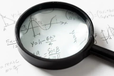 Mathematical Equations and Graph with Magnifying Glass Stock Photos