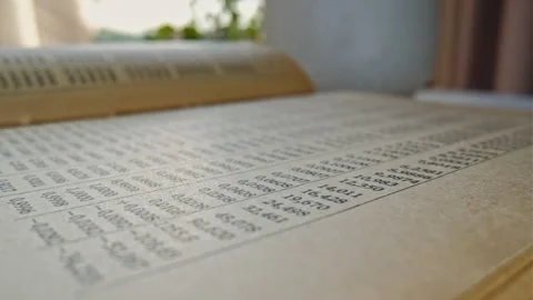 Mathematical Tables Book with Lists of Numbers Showing Results of Calculation Stock Footage 249021077