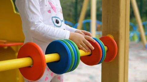 Mathematics can be fun. Little girl in playground. Focus is on hand. Close up. Video stock 100768895