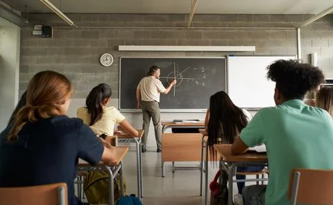 Mathematics teacher teaching classes at the major school. Back to school. Stock Photos