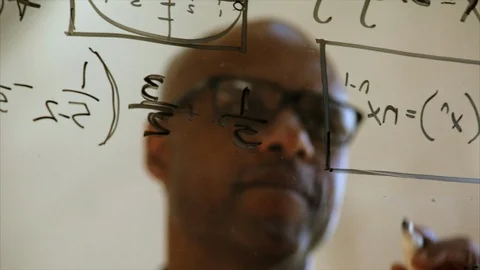 Mathematition making calculations on a clear board. Stock-Footage 88406050