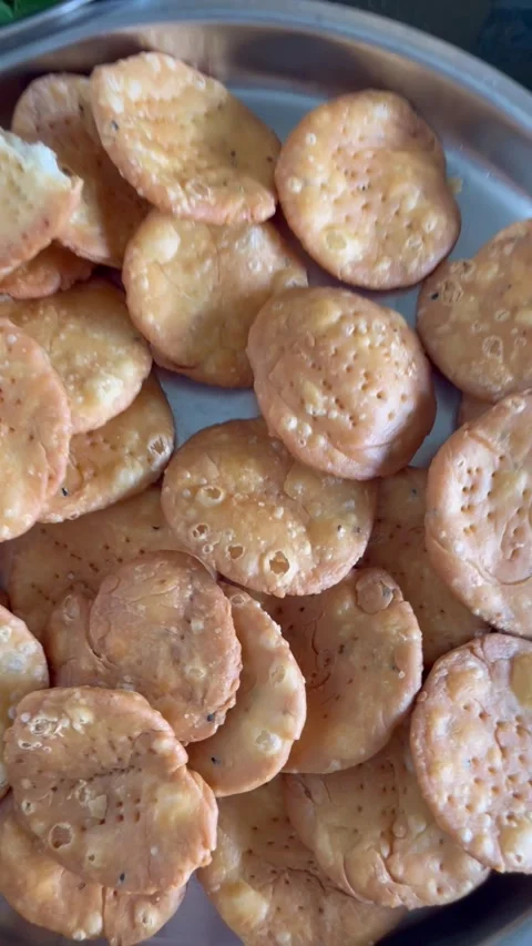 Mathri or matthi deep fried tea time snack made of whole wheat flour Stock Footage 338373605
