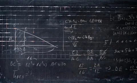 Maths formulas written by white chalk on the blackboard background. Stock Photos