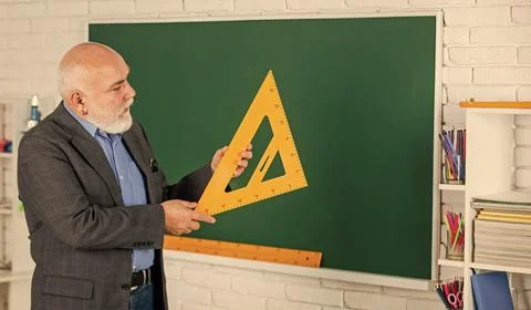 Maths Problem Solving. senior man teacher use math triangle tool. bearded tutor Foto stock