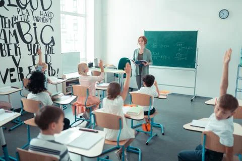 Maths teacher reading a mathematical problem in the classroom. Stock Photos