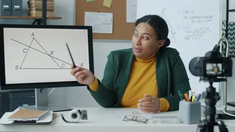 Maths teacher recording tutorial for educational vlog speaking using computer 動画素材 204092321