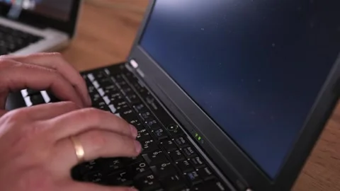 Matrix code on screen, close-up male hands, typing program code on laptop. Stock Footage 243581325