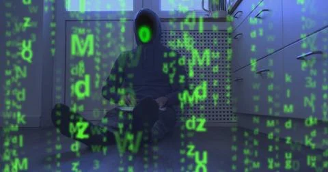 Matrix video effect, binary code instead of face of hooded programmer sitting on Stock Photos