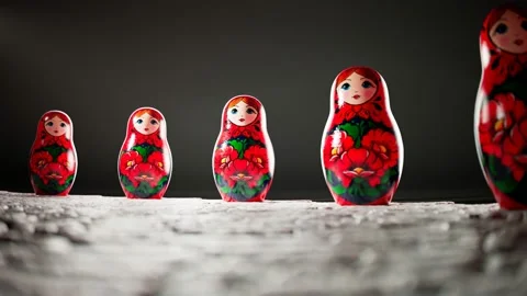 Matryoshka dolls placed in a circle. A camera follows one babushka after another Stock Footage 145766435