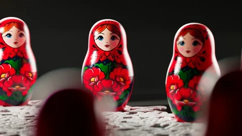 Matryoshka dolls placed in a circle. A camera follows one babushka after another Stock Footage 145766511