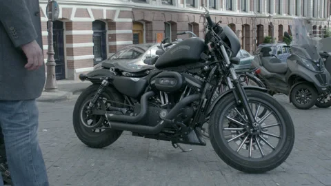 Matte Black Harley-Davidson Motorcycle Parked on City Street Stock Footage 344603675