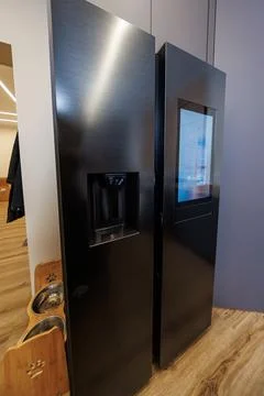 Matte black side by side refrigerator with touchscreen and dispenser Stock Photos