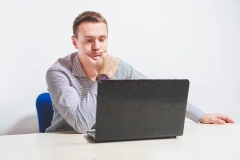 Matte toned image. young businessman working on laptop in office, being conce Stock Photos