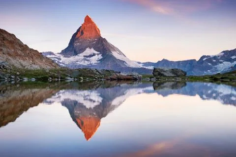 Matterhorn and reflection on the water surface during sunrise. Stock Photos