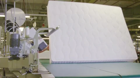 Mattress assembly line at a boxspring bed factory in slow motion, worker 스톡 동영상 270105788