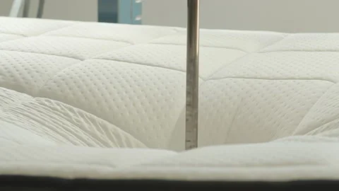 Mattress being tested with hydraulic press in mattress production facility Stock Footage 163206157