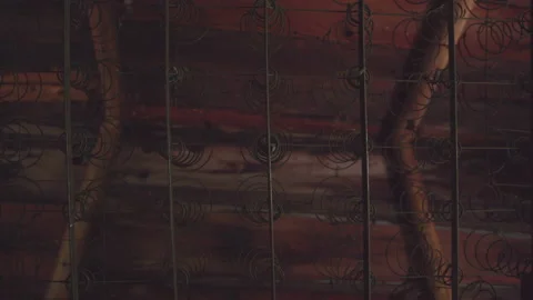 Mattress frame view from bellow in old attic / Hand held looking up rotation Stock Footage 130884656