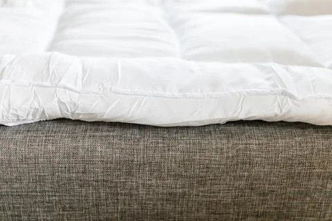 A mattress topper is placed on the sofa to make it more comfortable for sle.. Stock Photos