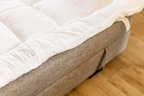 A mattress topper is on the sofa to provide extra comfort for sleeping. The.. Stock Photos
