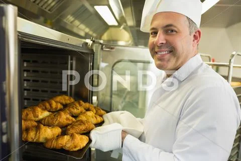 Mature baker smiling proudly at the camera Stock Photos